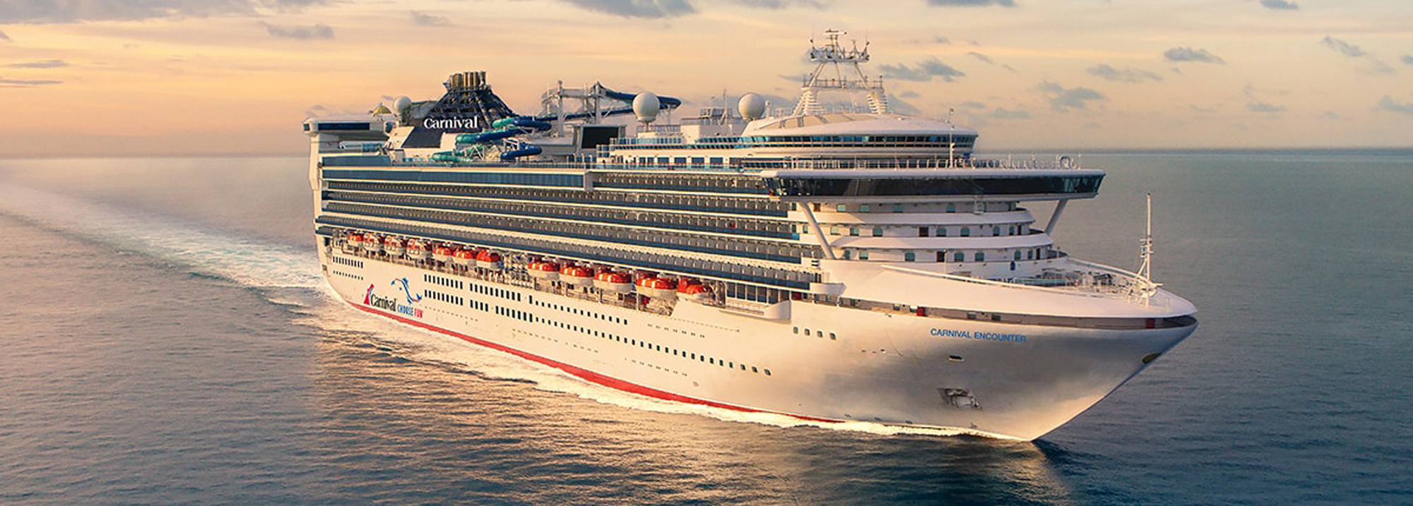 Carnival Cruise Ship at Golden Hour A large white Carnival cruise ship sailing across calm waters during sunset, creating a serene