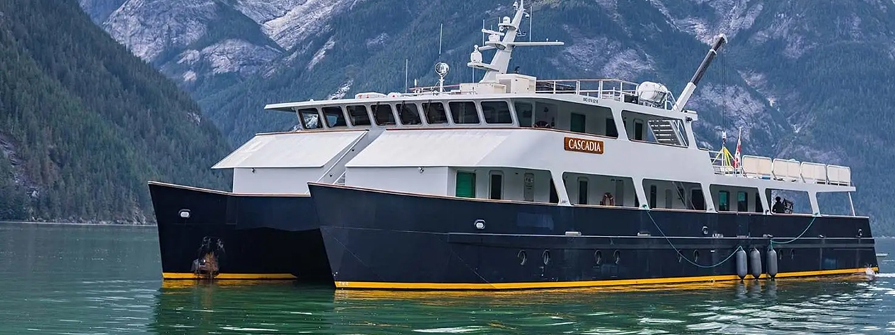 MV Cascadia Expedition Vessel in Alpine Lake The MV Cascadia, a modern expedition cruise vessel, is anchored in a pristine alpine lake