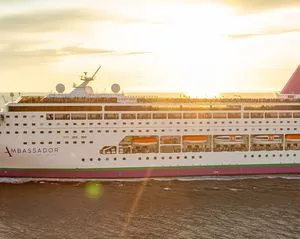 Cruise Ship at Golden Hour Dockside A large modern cruise ship is moored at port during golden hour sunset, displaying