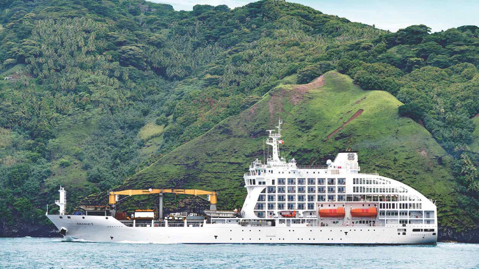 Aranui 5 Expedition Ship in Tropical Anchorage The Aranui 5, a white expedition cruise ship operated by Aranui Cruises, is anchored in pristine
