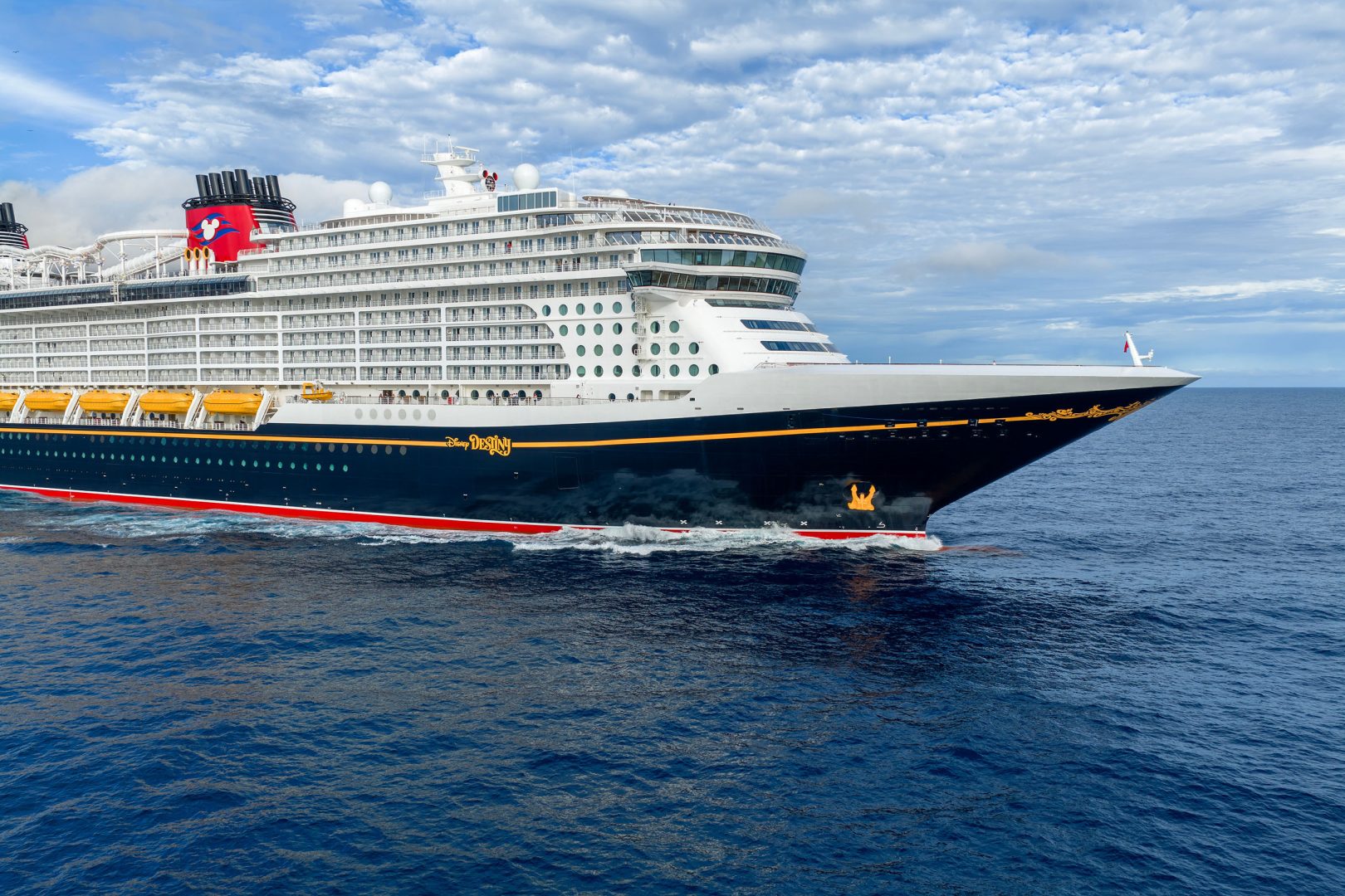 Disney Cruise Line Ship at Sea A large modern cruise ship with distinctive Disney branding and the characteristic red funnel