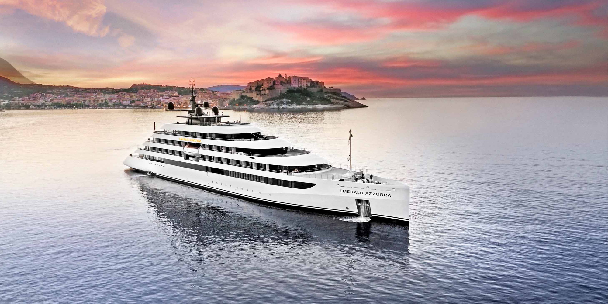Emerald Azzurra Luxury Yacht at Coastal Sunset A sleek white luxury yacht named Emerald Azzurra cruising near a picturesque Mediterranean coastal