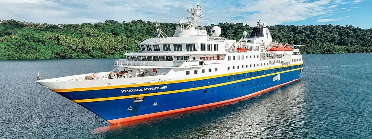 Heritage Adventurer Expedition Cruise Ship The Heritage Adventurer, an expedition cruise vessel, is anchored in clear tropical waters