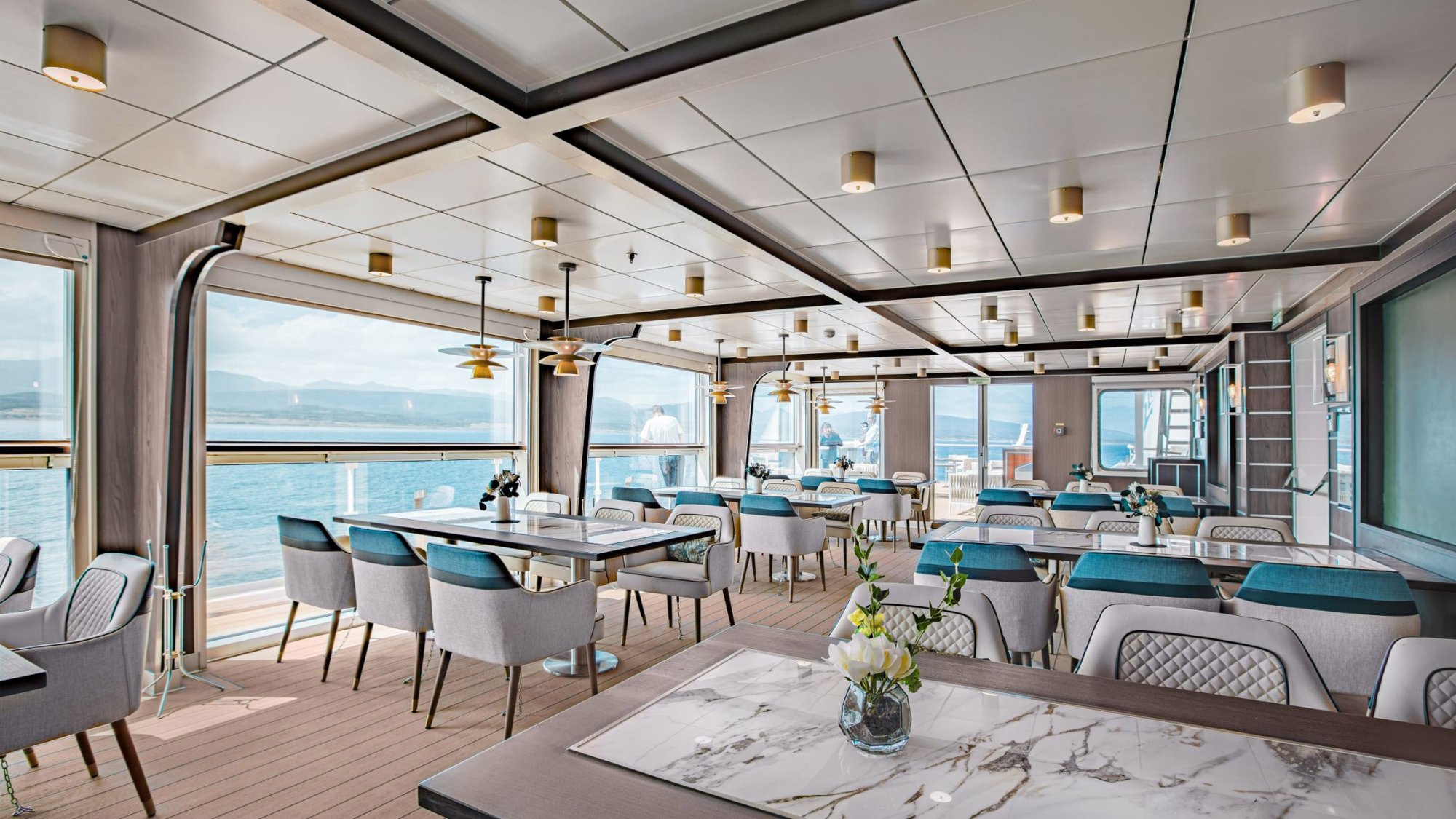 Ocean Victory Panorama Specialty Restaurant An elegant specialty dining venue aboard the Ocean Victory cruise ship, featuring floor-to-ceiling