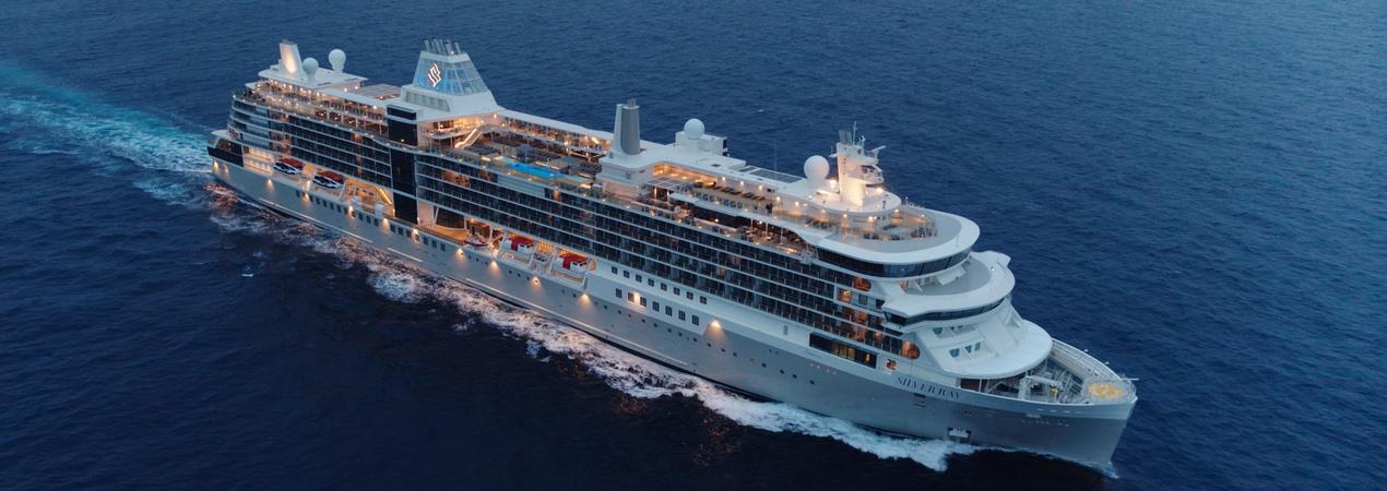 Luxury Cruise Ship at Sea A large modern cruise ship photographed from an aerial perspective, sailing through deep blue ocean