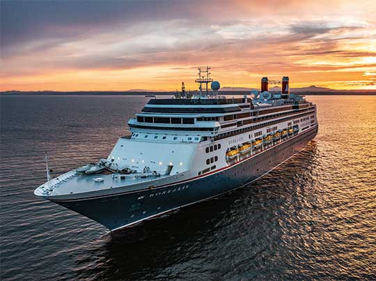 Borealis Cruise Ship at Sea at Sunset A large modern cruise ship, the Borealis, sails through calm waters during a stunning golden