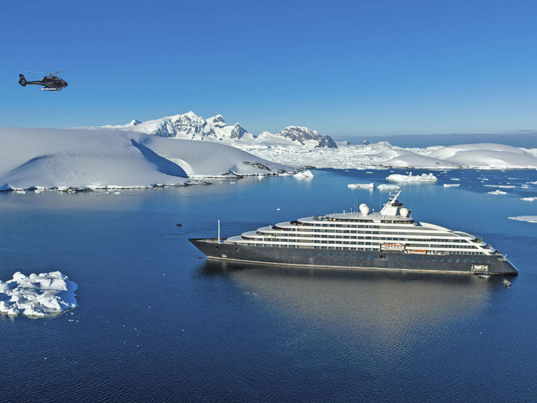 Silversea Eclipse at Fish Islands with Helicopter A luxury expedition cruise ship, the Silversea Eclipse, anchored in pristine Antarctic waters