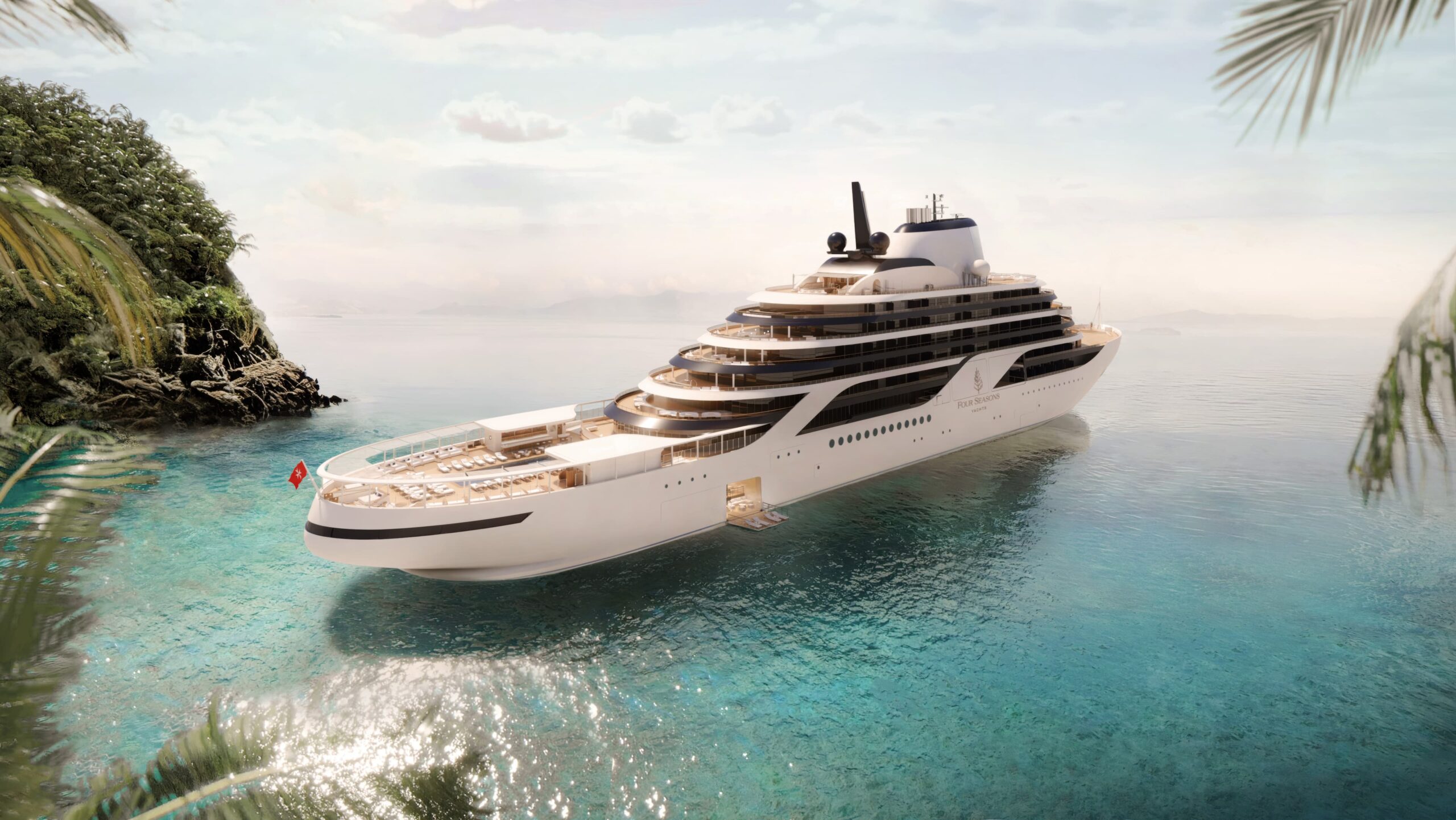 A modern luxury expedition yacht anchored in crystal-clear turquoise tropical waters near a lush