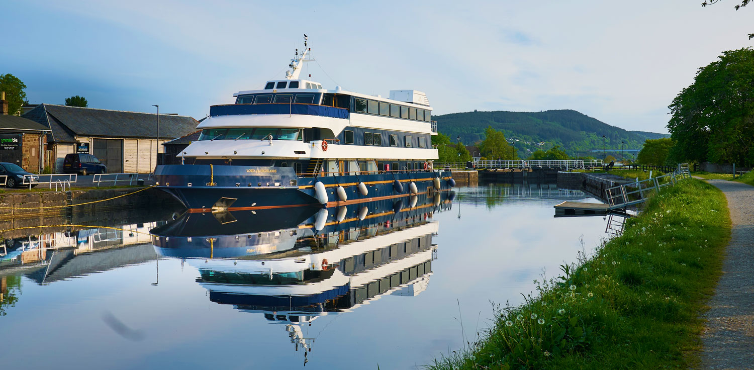 Luxury River Cruise Vessel at Loth Muirtown A sophisticated multi-deck river cruise ship moored at a serene inland waterway, reflected