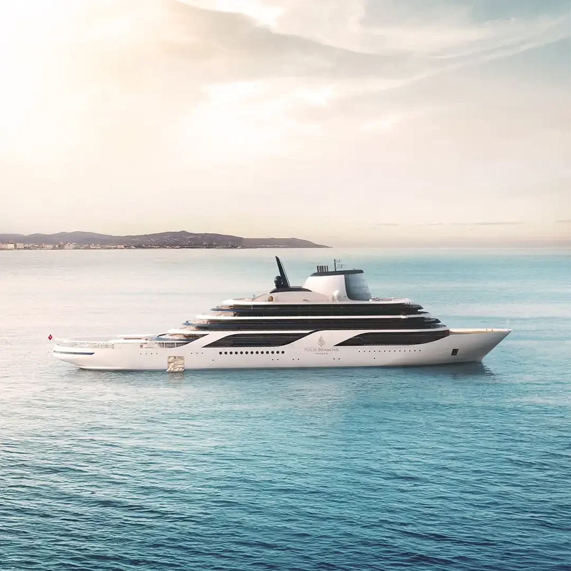 A modern luxury cruise ship with elegant white hull and black striping is anchored in crystal-clear