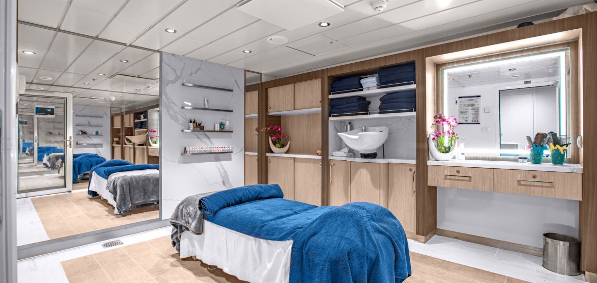 Modern Cruise Ship Cabin Suite with Bathroom A luxurious and contemporary cruise ship cabin featuring a spacious bedroom with blue bedding