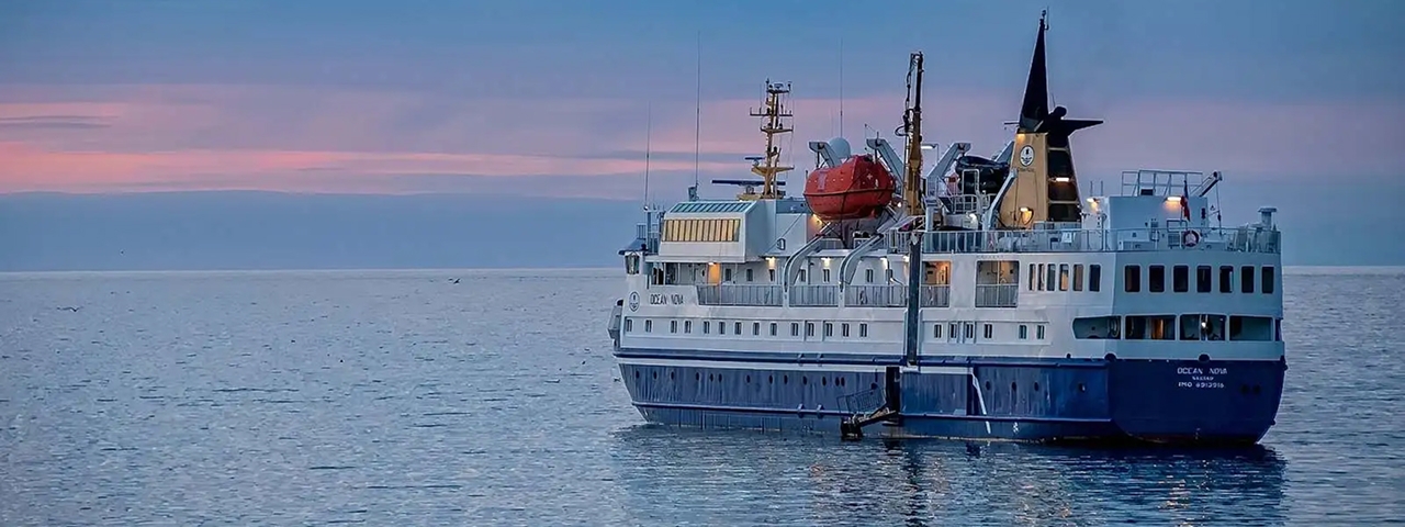 Ocean Nova Expedition Cruise Ship at Sea A modern expedition cruise ship with distinctive blue and white hull, equipped with advanced