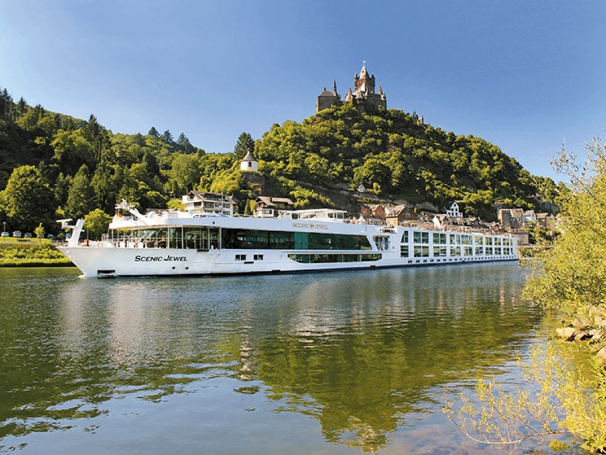 The Scenic Jewel, a modern river cruise ship, navigates through the Danube River valley with