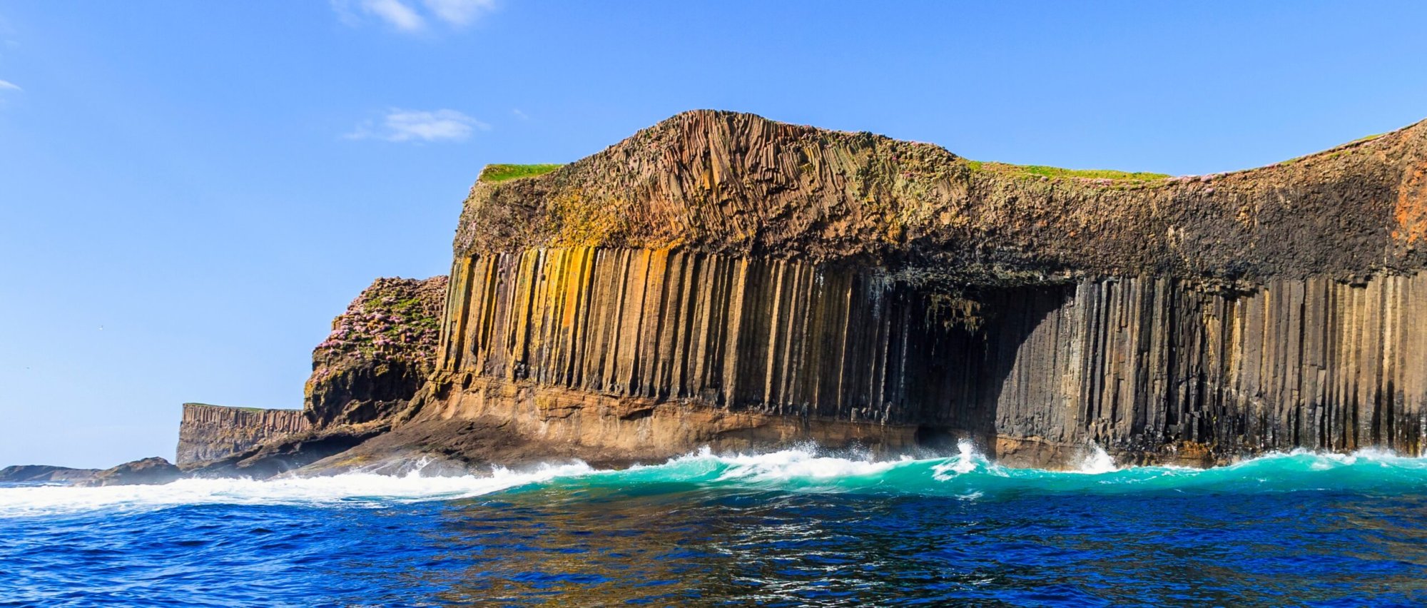 Fingal’s Cave Basalt Columns and Ocean Waves A dramatic coastal formation featuring distinctive hexagonal basalt columns rising from the sea