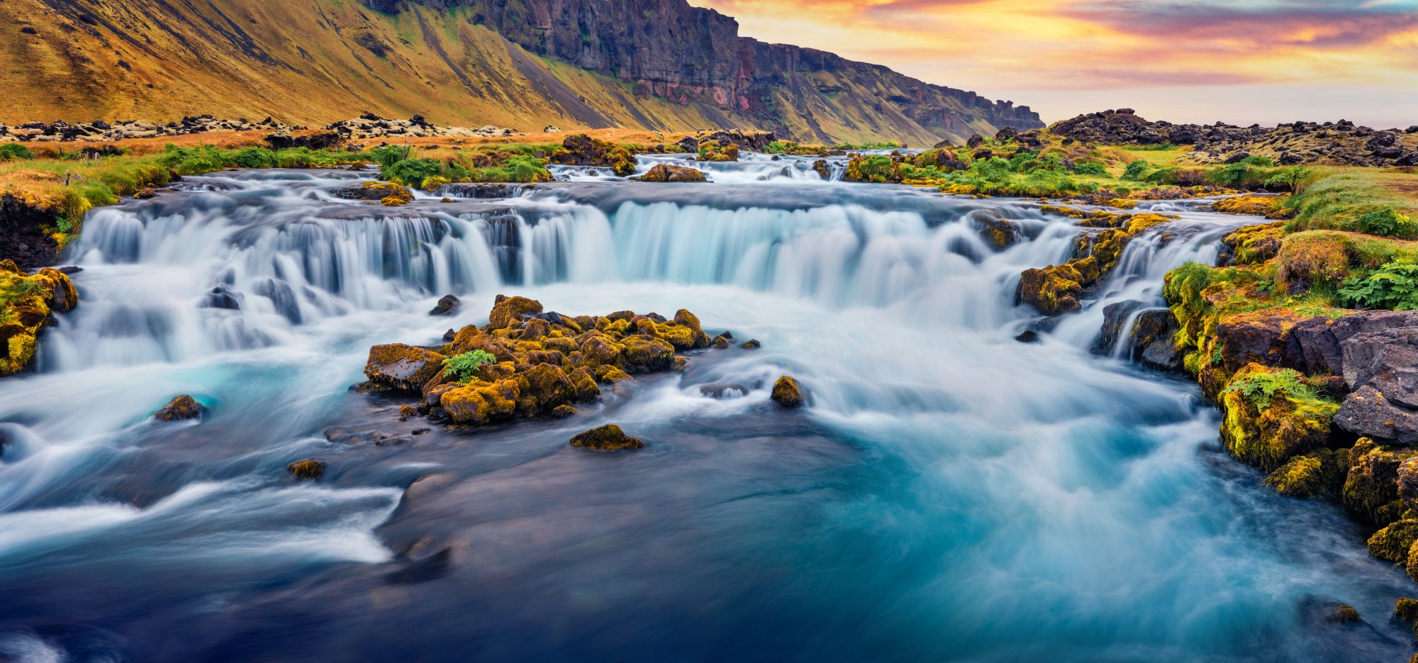 Cascading Waterfalls in Icelandic Highland Valley A breathtaking landscape featuring multiple cascading waterfalls flowing through a pristine