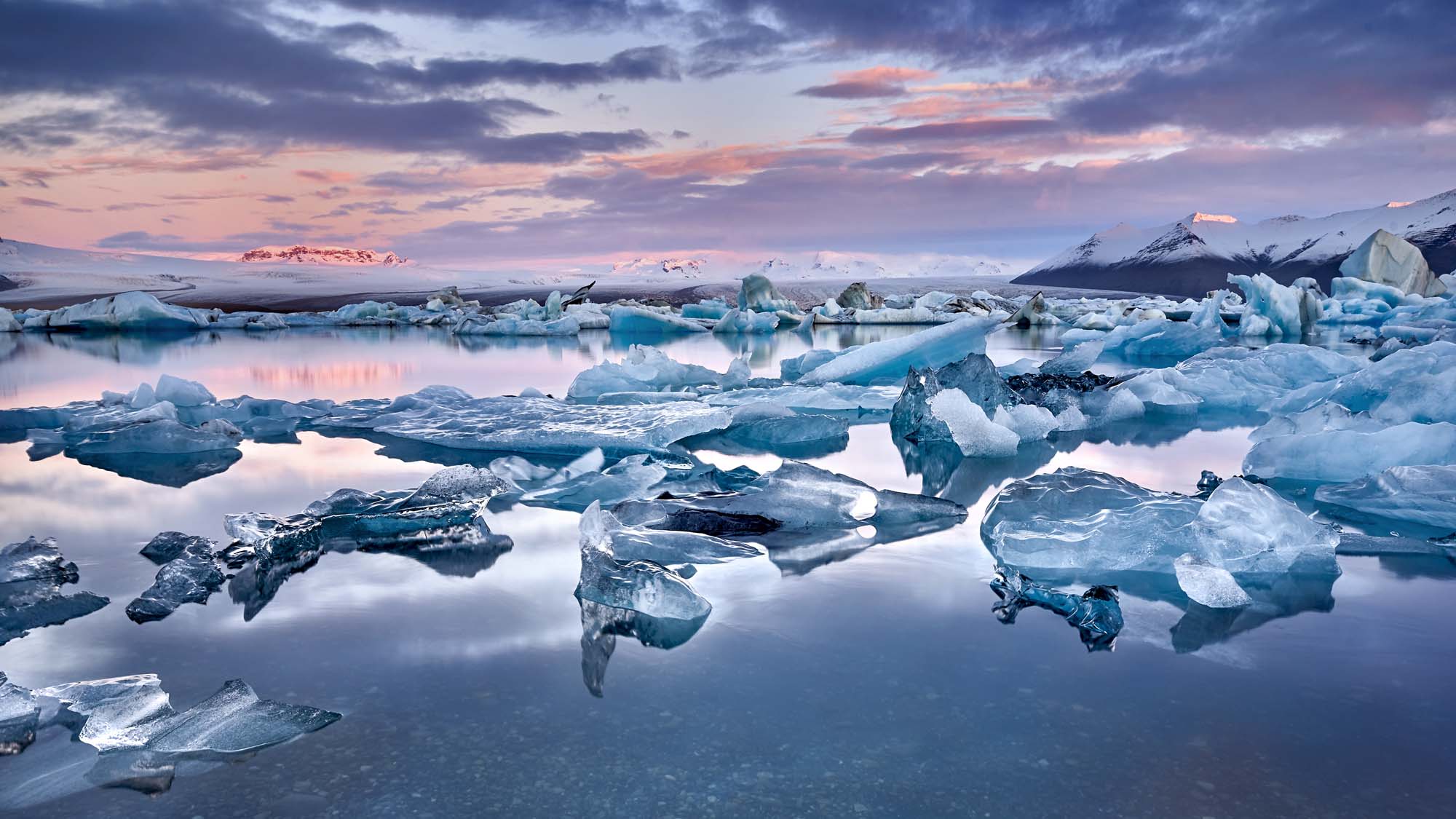 Jökulsárlón Glacier Lagoon at Sunset A breathtaking panoramic view of Iceland's Jökulsárlón glacier lagoon at twilight, featuring
