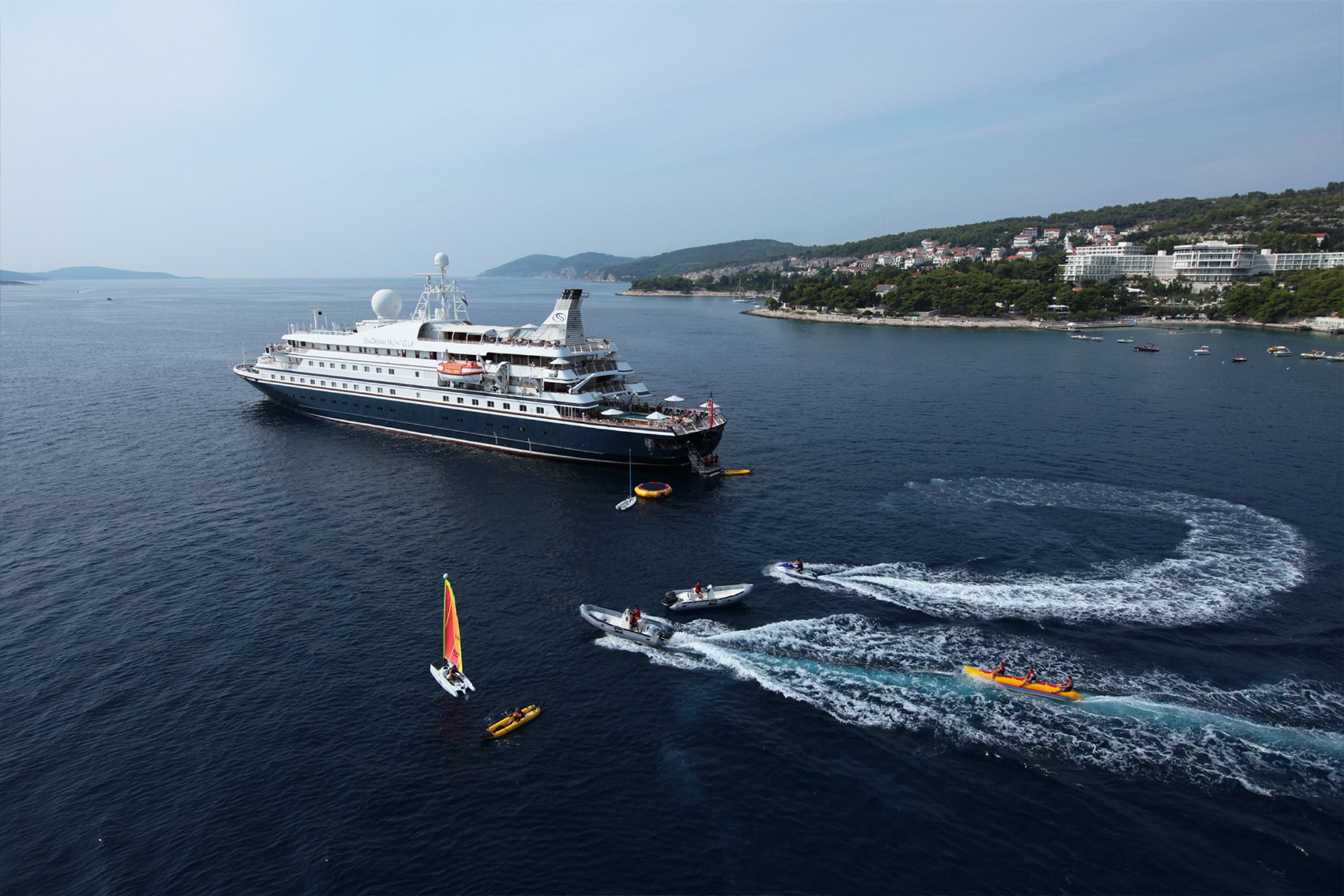 Luxury Cruise Ship Anchored in Adriatic Bay A large expedition cruise ship with distinctive dark hull and white superstructure is anchored