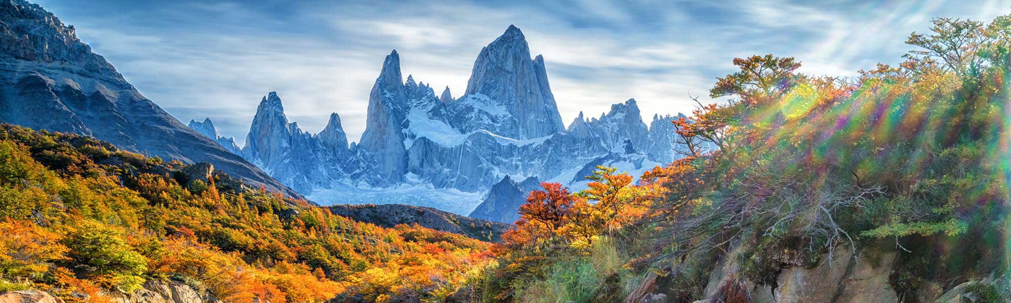 Mount Fitz Roy with Autumn Forest A stunning landscape featuring the iconic granite peaks of Mount Fitz Roy framed by vibrant autumn