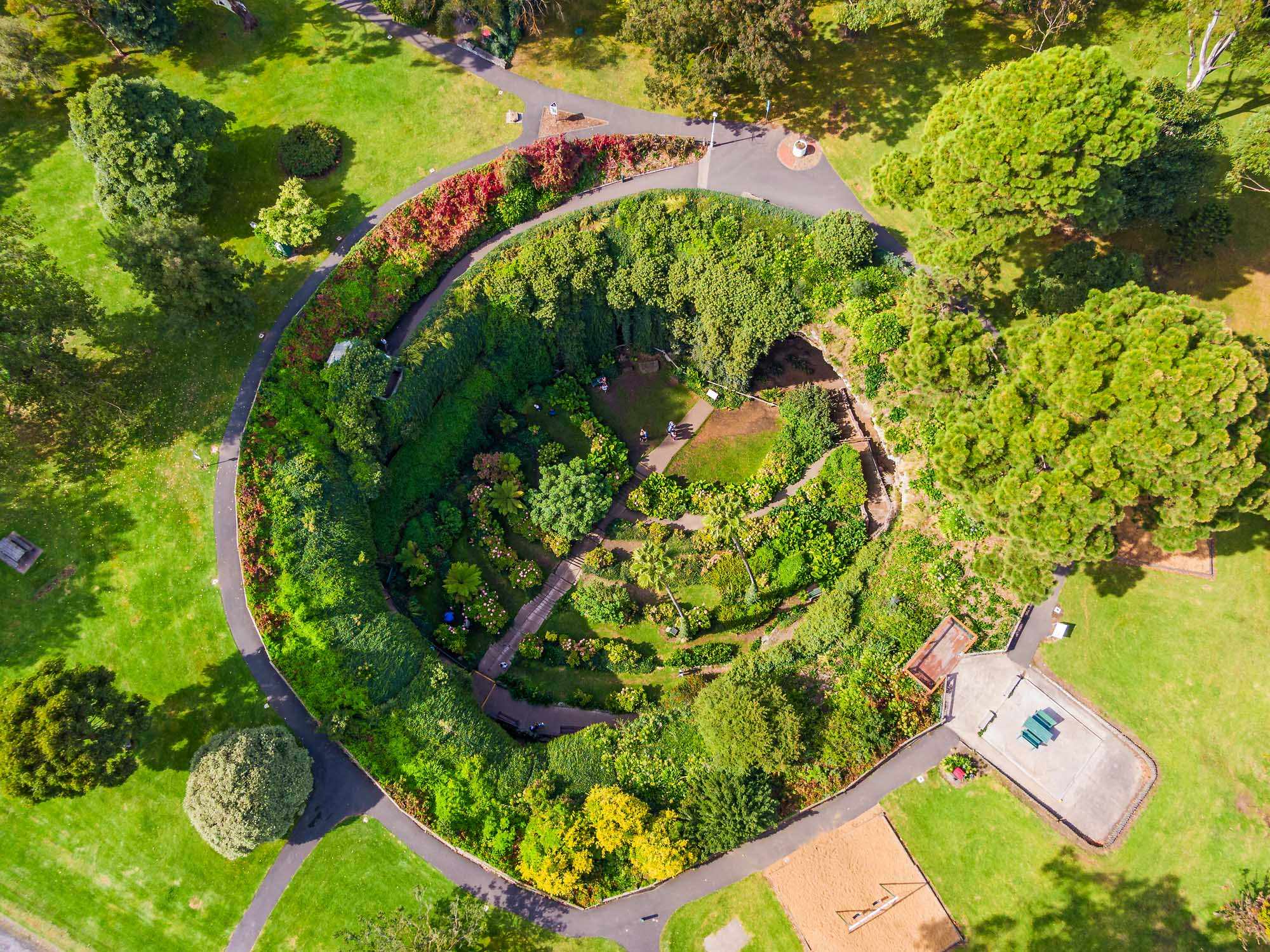 Aerial View of Manicured Garden with Pathways An overhead aerial photograph of a beautifully landscaped garden featuring winding pathways, lush