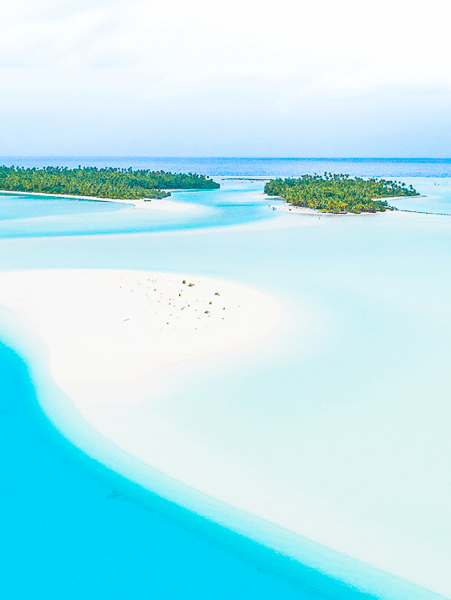 Aerial View of One Foot Island, Aitutaki An aerial photograph showcasing the stunning turquoise lagoon and pristine white sand beach of One
