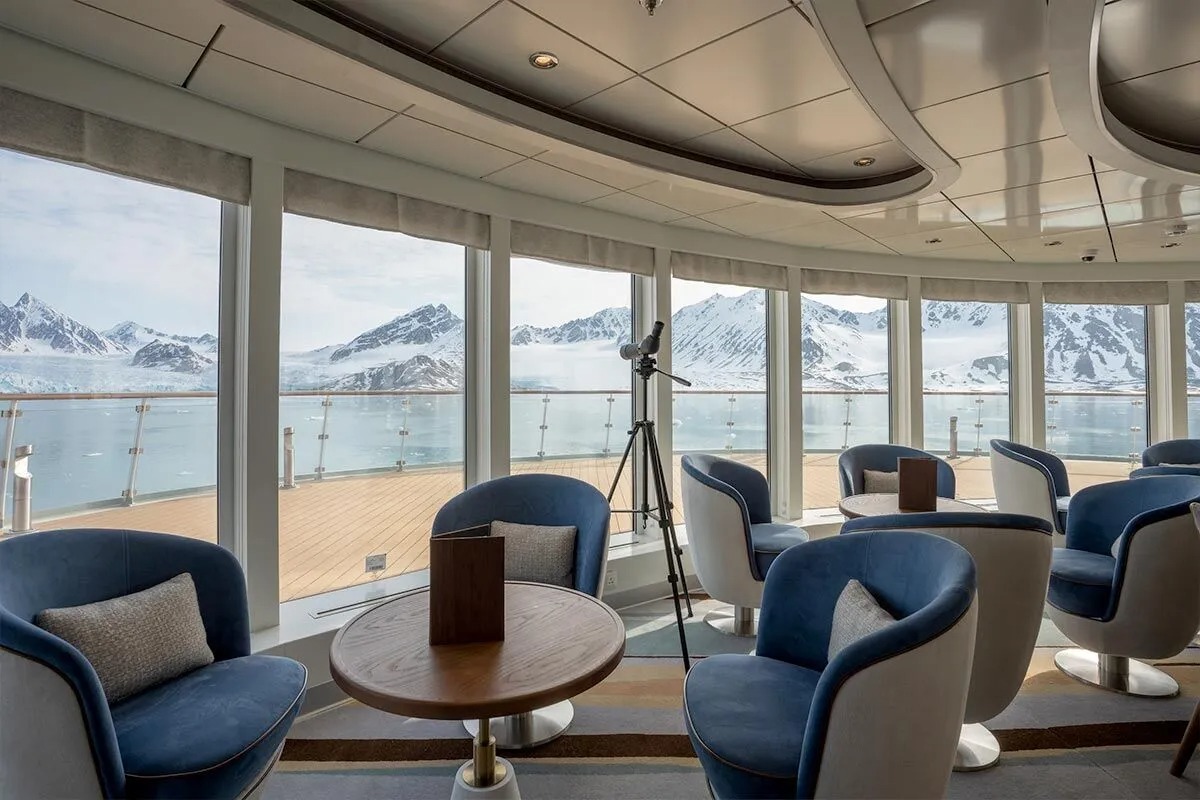 Albatros Panoramic Viewing Lounge with Arctic Mountains A luxurious panoramic viewing lounge aboard the Albatros cruise ship, featuring floor-to-ceiling