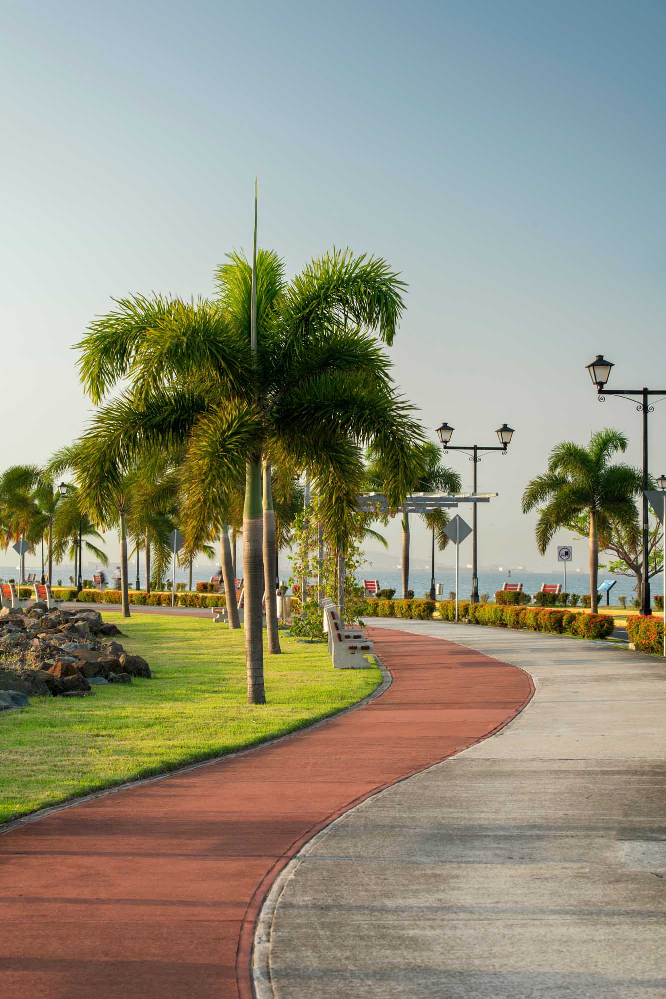 Amador Causeway Waterfront Promenade, Panama City A scenic waterfront promenade at the Amador Causeway in Panama City, featuring palm-lined walkways