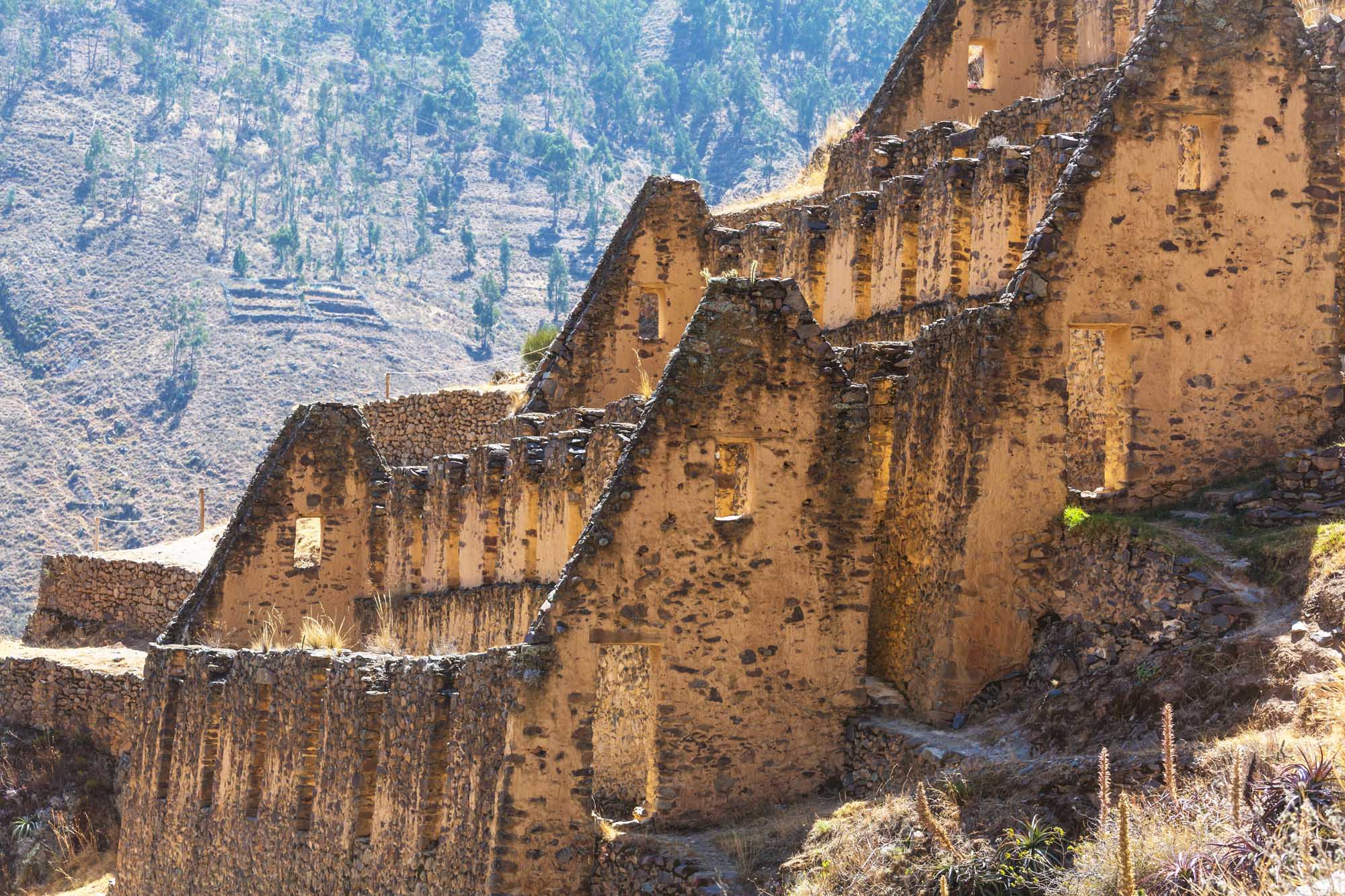 Ancient Inca Ruins Near Cusco, Peru Weathered stone structures of Inca ruins nestled in a mountainous landscape near Cusco, Peru