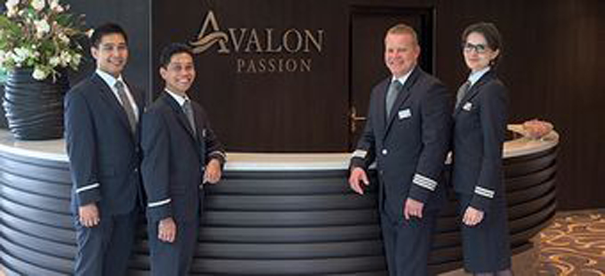 Avalon Passion Crew Welcome at Entrance Five uniformed staff members stand formally at the entrance to the Avalon Passion, a river cruise