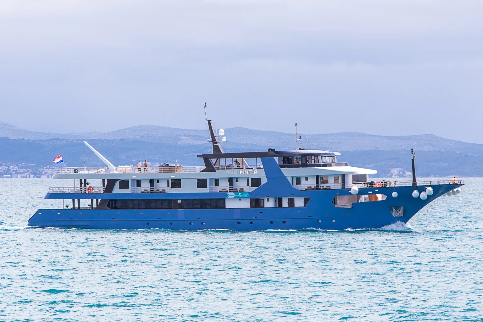 Ave Maria Expedition Cruise Ship at Anchor A striking blue and white expedition cruise vessel, the Ave Maria, anchored in calm Mediterranean