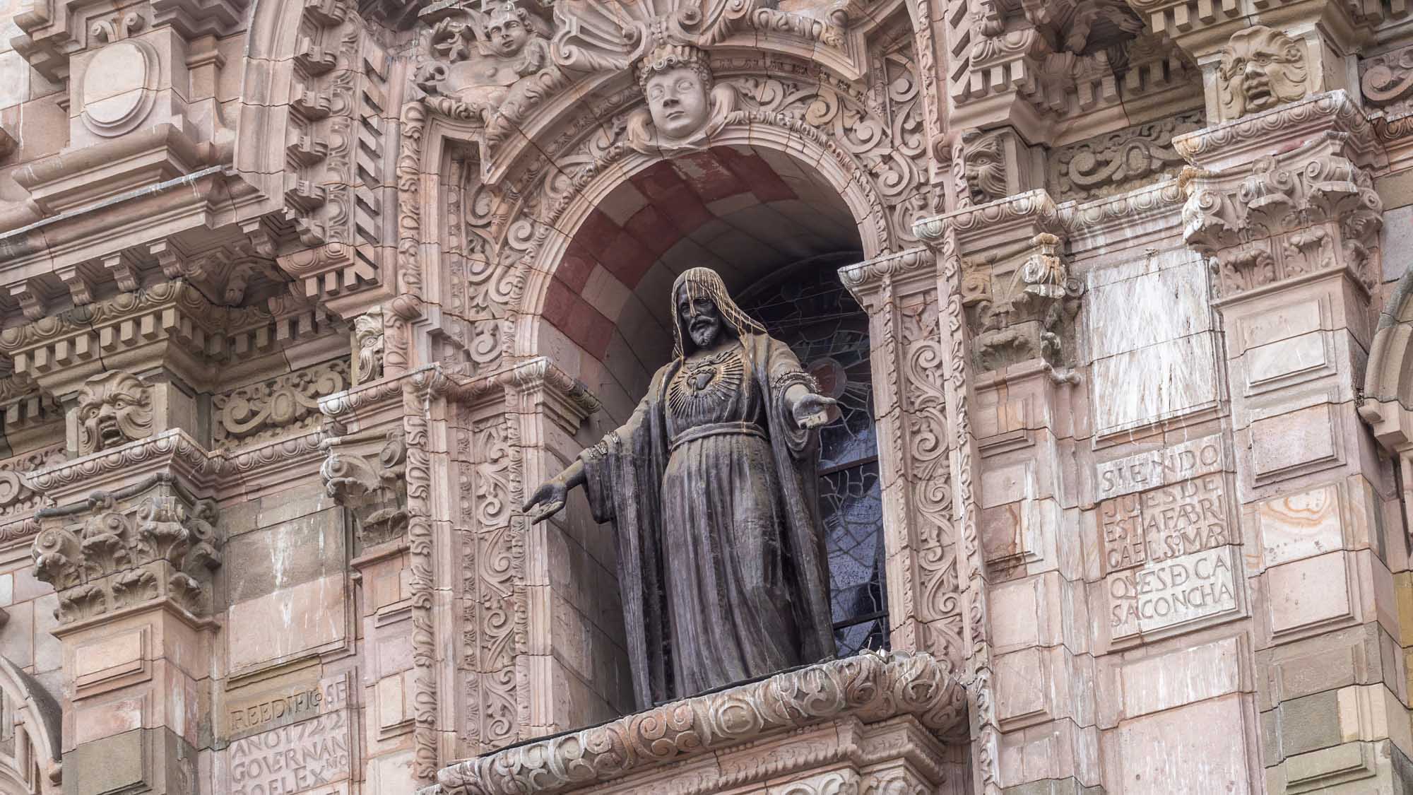 Basilica Cathedral of Lima Ornate Stone Statue A detailed view of an ornately carved stone statue set within an elaborate Baroque architectural