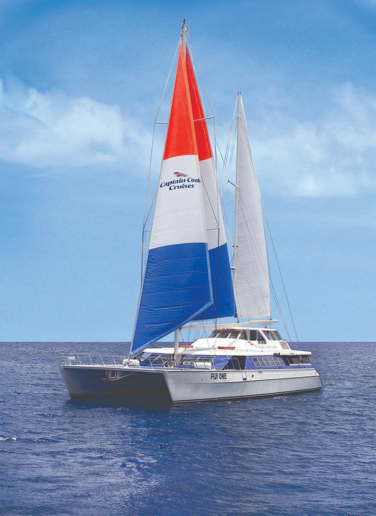 Captain Cook Cruises Fiji One Sailing A modern catamaran cruise ship operated by Captain Cook Cruises, captured under full sail