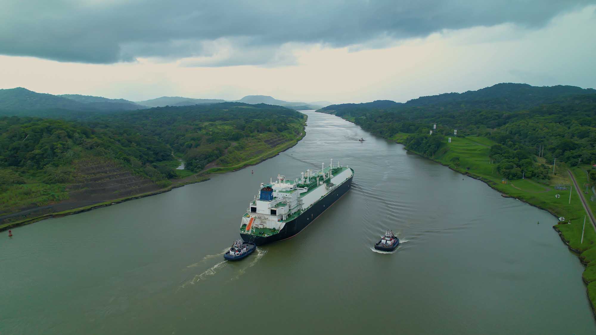 Cargo Ship Transiting Panama Canal with Tugboats A large cargo vessel is escorted by tugboats through the Panama Canal, one of the world's most