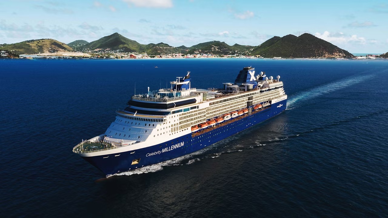 The Celebrity Millennium, a large modern cruise ship with distinctive blue and white hull, sails