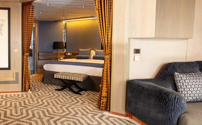 Celestyal Cruises Luxury Cabin with Sleeping Area A modern cruise ship cabin featuring a separate sleeping alcove with a queen-sized bed