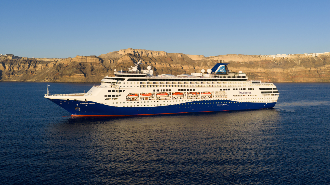 Celestyal Cruises Ship at Santorini A modern cruise ship operated by Celestyal Cruises is anchored in the azure waters off Santorini
