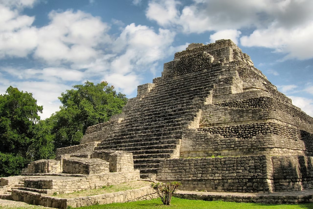 A well-preserved ancient Mayan pyramid structure built with precisely stacked stone blocks