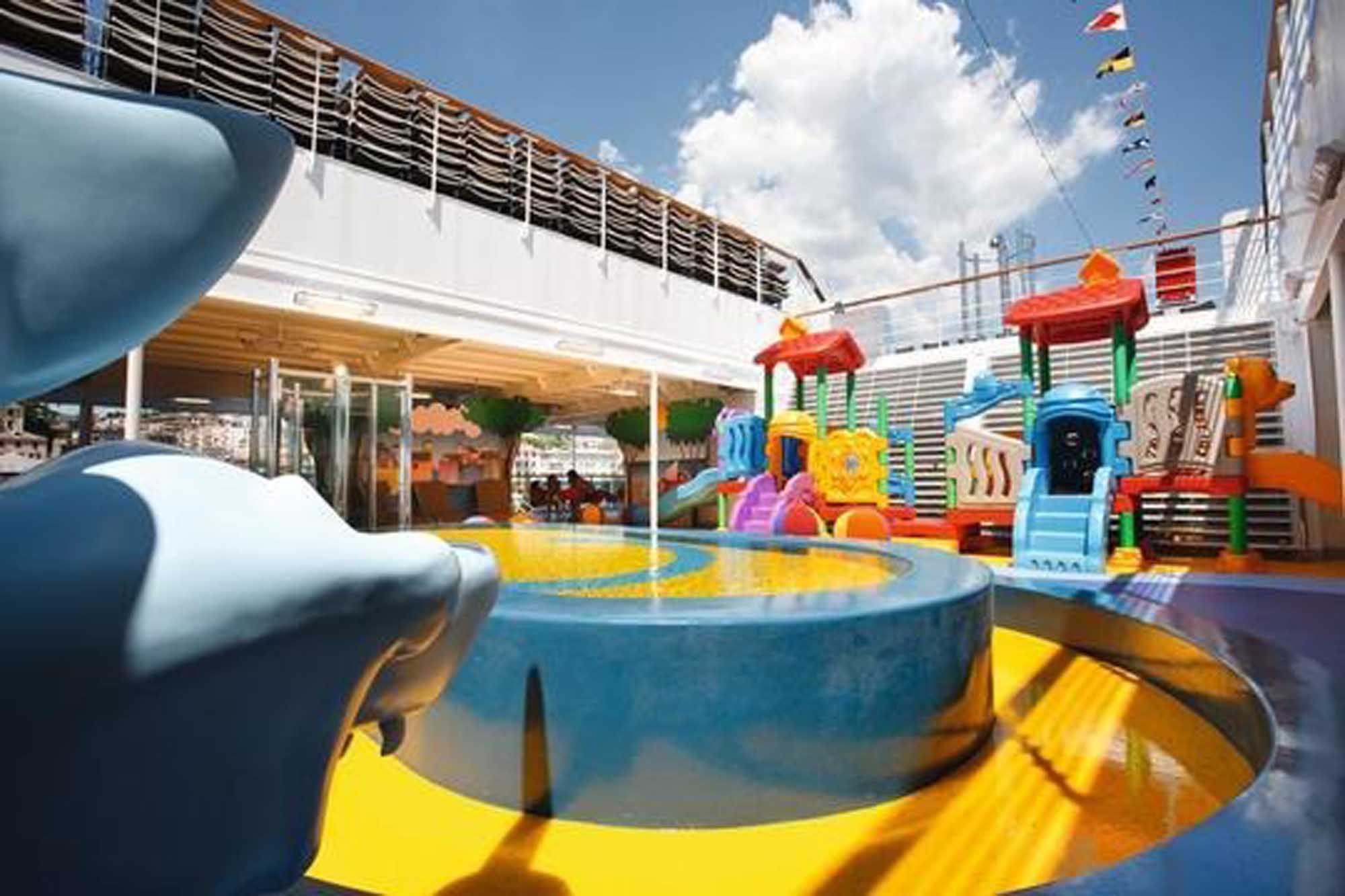 Colorful Children’s Play Area on Cruise Ship Deck A vibrant outdoor children's play area aboard a cruise ship, featuring a bright blue splash pool