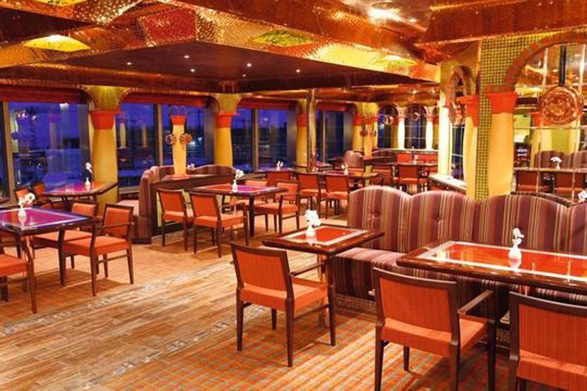 Costa Cruise Ship Modern Lounge Area A contemporary cruise ship lounge and entertainment venue featuring warm orange and gold tones
