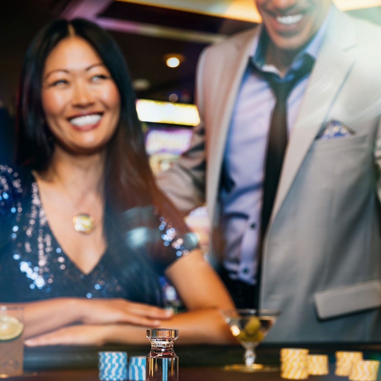 Couple Enjoying Casino Gaming at Princess Cruises A well-dressed couple smiles at a casino roulette table aboard a Princess Cruises ship, with