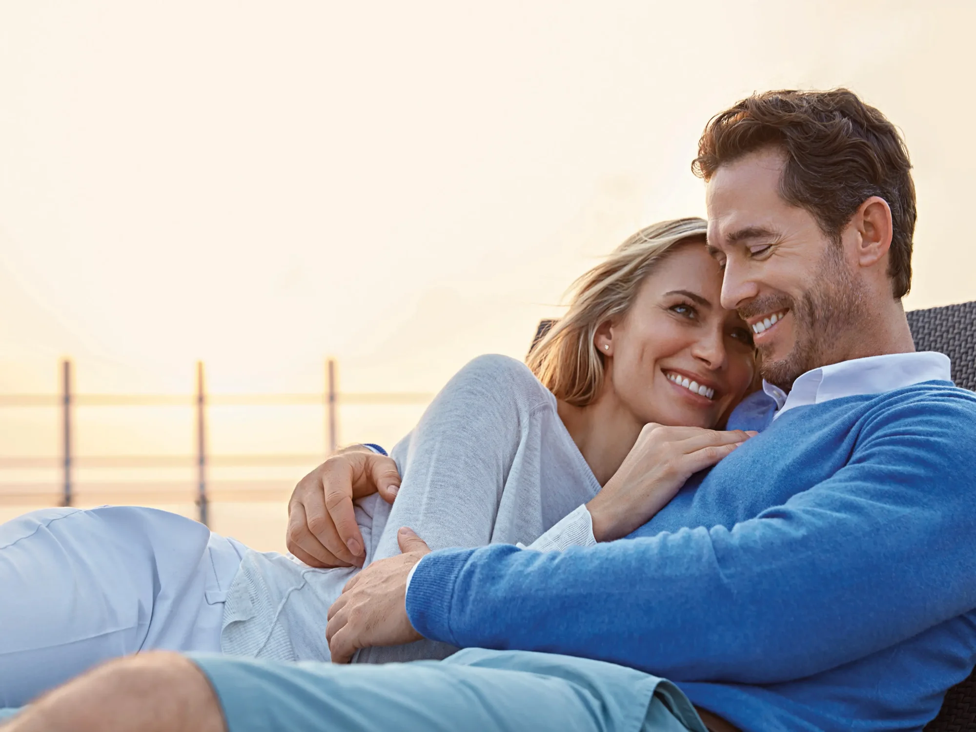 Couple Relaxing on Hapag-Lloyd Cruises Ship Deck A happy couple enjoys a romantic moment together on the deck of a Hapag-Lloyd Cruises ship