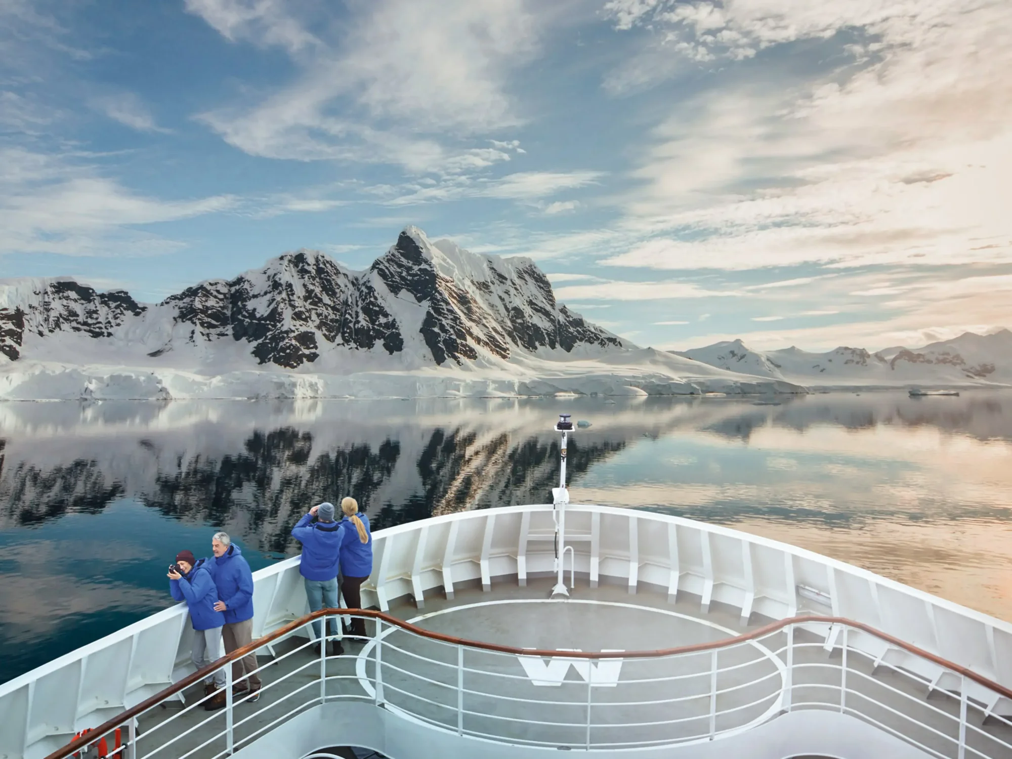 Cruise Ship Observation Deck in Antarctic Paradise Bay Passengers aboard a Hapag-Lloyd Cruises expedition vessel observe pristine snow-capped mountains