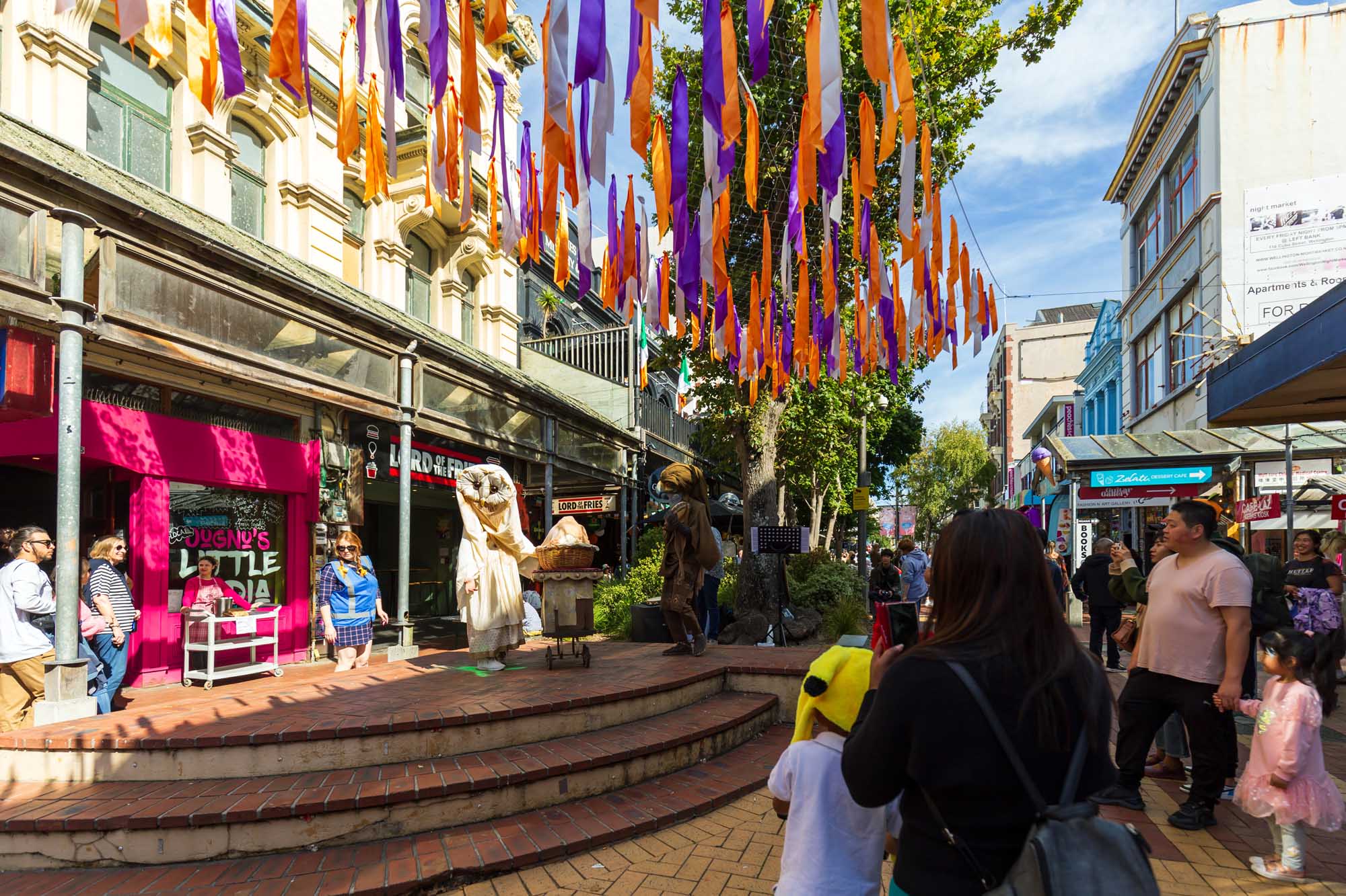 Cuba Dupa Festival Street Scene in Wellington A vibrant street celebration in Wellington, New Zealand featuring colorful purple and orange ribbon