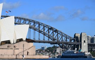 Douglas Mawson Cruise Ship Arrives in Sydney Harbour The expedition cruise ship Douglas Mawson dwarfed by the iconic Sydney Harbour Bridge and Sydney