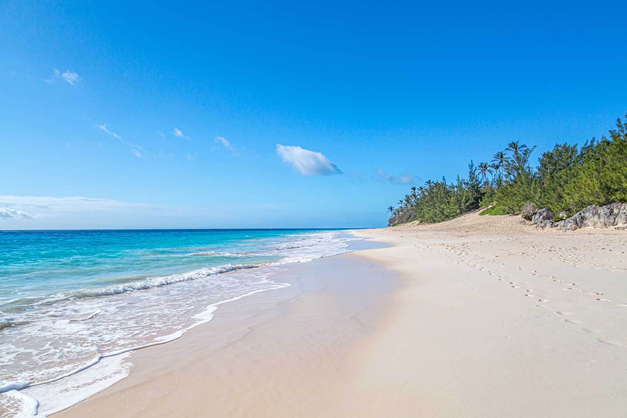 Elbow Beach Bermuda with Turquoise Waters A pristine sandy beach on Bermuda's Elbow Beach stretches along crystal-clear turquoise waters