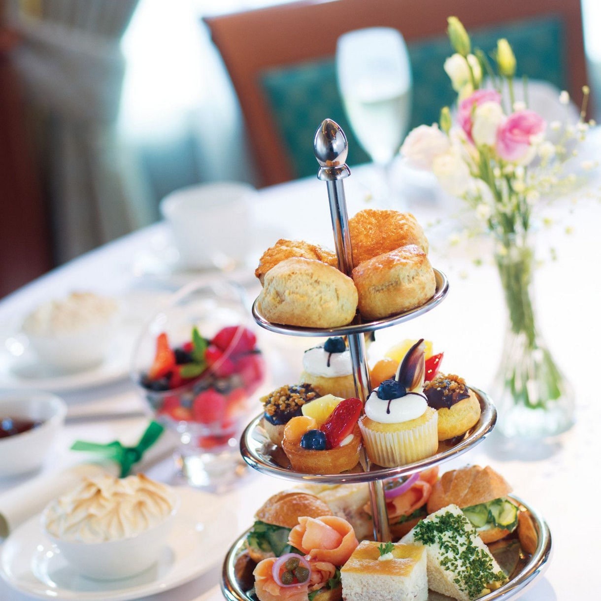 Elegant Afternoon Tea Service on Princess Cruises A luxurious tiered afternoon tea presentation featuring pastries, scones, finger sandwiches