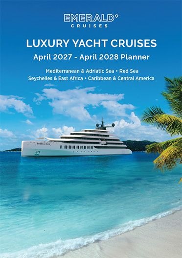 Emerald Cruises Luxury Yacht in Tropical Waters A luxurious Emerald Cruises yacht anchored in pristine turquoise waters off a tropical island beach