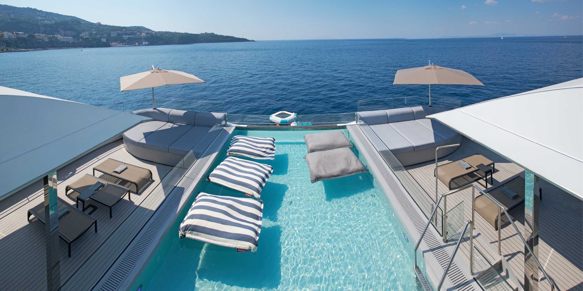 Emerald Sakara Aqua Pool Deck Overview A stunning aerial view of a modern cruise ship's pool deck featuring a turquoise infinity pool