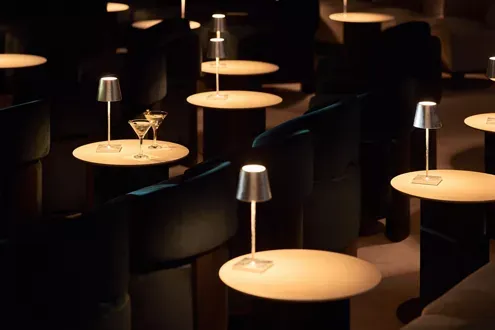 Explora Journeys Lounge with Ambient Lighting An elegant lounge area aboard an Explora Journeys vessel, featuring a sophisticated modern design