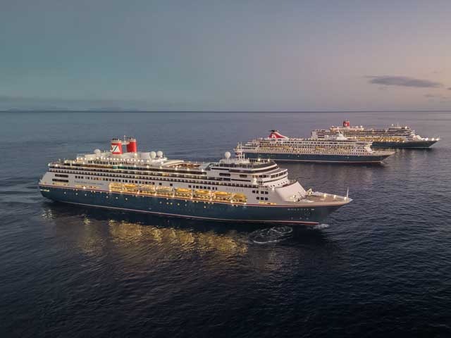 Three cruise ships from the Fred. Olsen fleet anchored in calm waters during golden hour