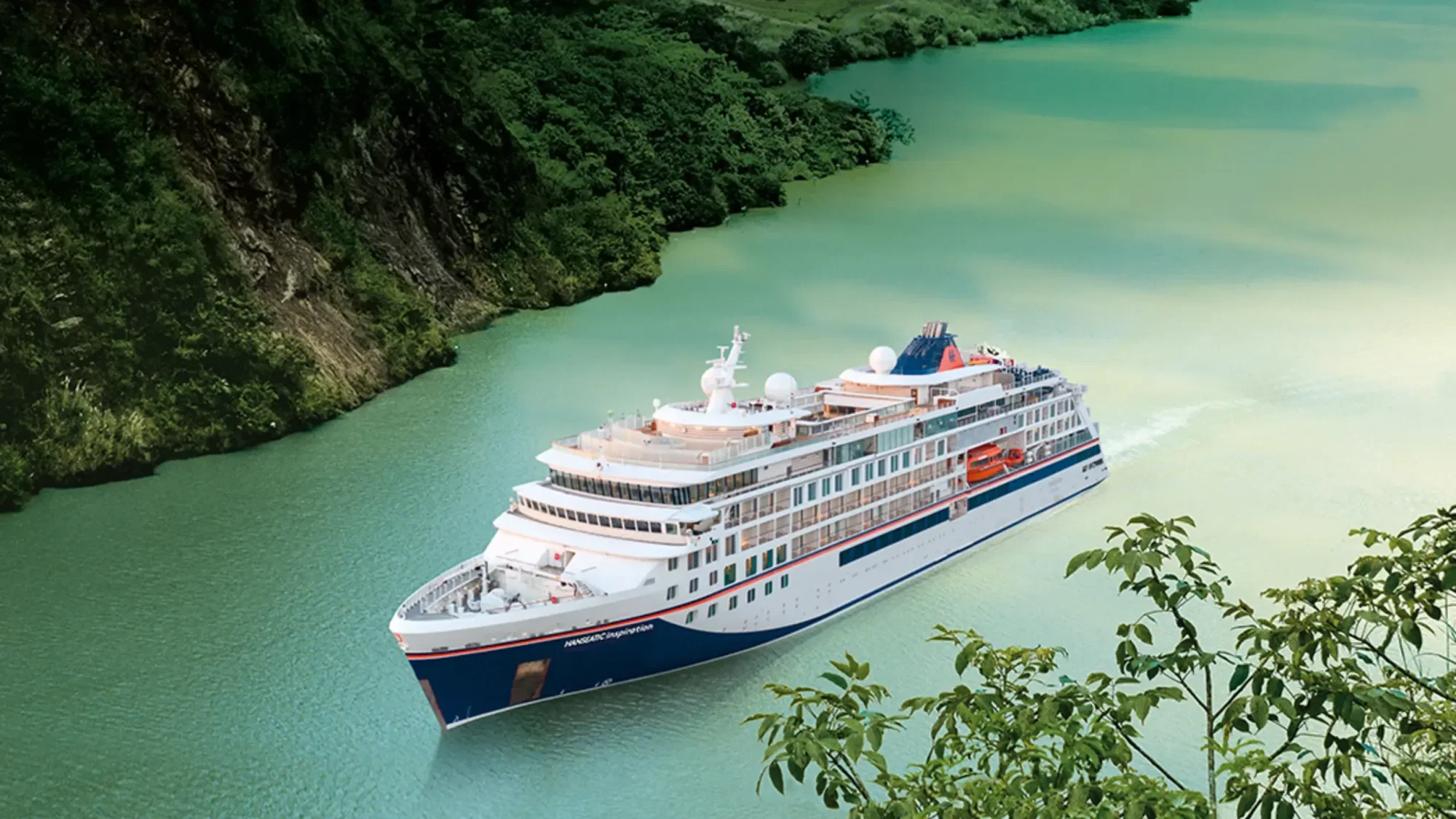 Hapag-Lloyd Cruise Ship in Turquoise Waters A modern expedition cruise ship operated by Hapag-Lloyd Cruises navigates through stunning